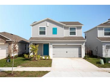 Charming two-story home with a well-manicured lawn and a bright, inviting entrance at 3987 Sagefield Dr, Harmony, FL 34773