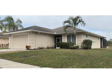 Charming single-story home with a well-maintained lawn and mature palm trees in a tranquil neighborhood at 2911 Sunset Vista Ct, Kissimmee, FL 34747