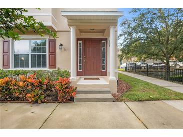 Inviting house entrance with brown door, columns, and landscaping at 207 Maplebrook Dr, Altamonte Springs, FL 32714