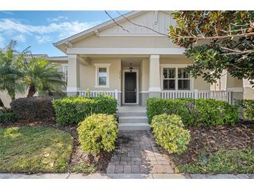 House exterior featuring a front porch and landscaping at 7910 Winter Wren St, Winter Garden, FL 34787