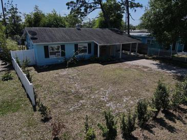 An aerial perspective showcasing a home with a spacious front yard in a quiet neighborhood setting at 5018 Figwood Ln, Orlando, FL 32808