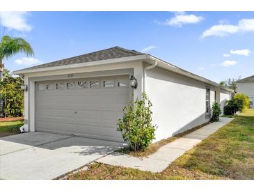 Attached garage with gray door and light-colored walls at 1533 Loch Avich Rd, Winter Garden, FL 34787