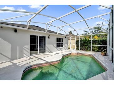 Screened-in pool area with clean water, privacy landscaping, and a white painted screened enclosure at 1533 Loch Avich Rd, Winter Garden, FL 34787