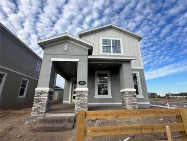 Two-story Craftsman home with stone accents and a welcoming front porch at 1342 Twelve Oaks Rd, Saint Cloud, FL 34771