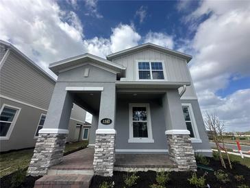 Beautiful two-story home with a covered porch, brick accents, and manicured landscaping at 1342 Twelve Oaks Rd, Saint Cloud, FL 34771