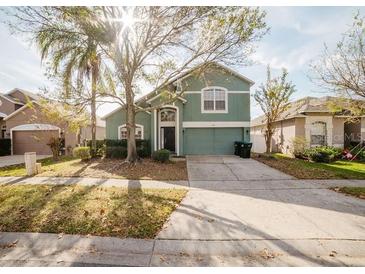 Two-story home with a well maintained lawn and a two car garage at 2142 Brandywine Falls Way, Orlando, FL 32824