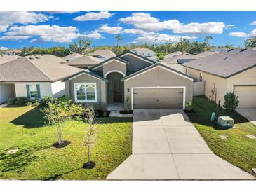 Attractive one-story house with a two-car garage and landscaped lawn at 6134 Dolostone Dr, Lakeland, FL 33811