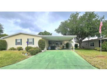 Charming single-story home featuring a covered carport and well-maintained lawn at 6604 Scenic Point Se Dr, Winter Haven, FL 33884