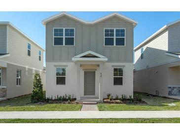 Two-story house with gray siding, and a manicured lawn at 434 Belmond Dr, Debary, FL 32713