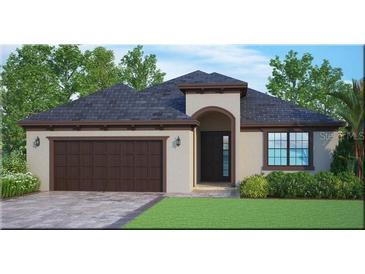 Home exterior showcasing a modern design, a two car garage, and landscaping at 1669 Markel Dr, Winter Garden, FL 34787