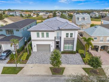 Stunning two-story home showcasing a paved driveway and a neutral color scheme at 1529 Corolla Ct, Reunion, FL 34747