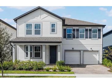 Two-story house with gray roof, white siding, and a two-car garage at 11218 Pixie Mandarin Ct, Winter Garden, FL 34787