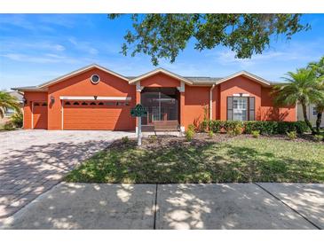 Charming one-story home featuring a two-car garage, well-maintained landscaping, and a welcoming front porch at 1221 Glendora N Rd, Kissimmee, FL 34759
