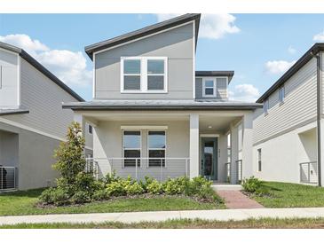 Charming two-story home with modern design, covered porch, and manicured landscaping for curb appeal at 5015 Railroad Vine Aly, Winter Garden, FL 34787