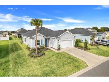 Single-story home with gray siding, landscaping, and driveway at 9132 Sw 57Th Ter, Ocala, FL 34476