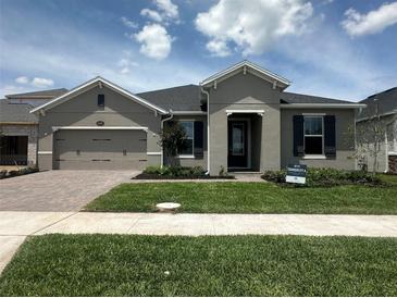 Charming single-story home featuring a well-manicured lawn and neutral-toned exterior at 5385 Park Guell St, St Cloud, FL 34771
