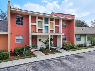 Charming multi-Gathering home featuring vibrant coral exteriors, colorful accents, and well-maintained landscaping at 4786 Tangerine Ave # 4786, Winter Park, FL 32792