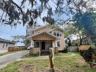 Charming two-story home with inviting front porch and mature trees at 545 Margaret Ct, Orlando, FL 32801