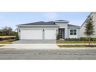 Two-car garage and front yard landscaping at 125 Citra Ln, Lake Mary, FL 32746