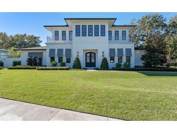 Stunning two-story home with a manicured lawn and a balcony, perfect for enjoying the outdoors at 1948 Rowena Ave, Orlando, FL 32803