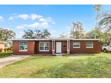 Front view of charming ranch house with green lawn at 2313 Savoy Dr, Orlando, FL 32808
