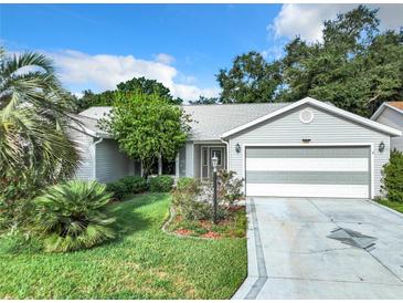 Charming single-story home featuring a well-maintained lawn and an attached two-car garage at 3904 Plantation Blvd, Leesburg, FL 34748