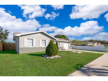 Single-story home with landscaped yard and attached garage at 7659 Nolton Way, Orlando, FL 32822