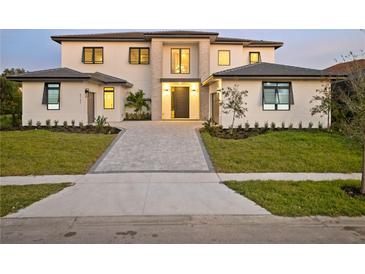 Stunning two-story home with a modern design and landscaped lawn at 5762 Emerington Cres, Orlando, FL 32819