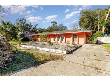 Ranch style home with a peach exterior and a spacious yard at 4028 Wendy Dr, Orlando, FL 32808