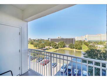 Enjoy the balcony view overlooking a tranquil pond and lush greenery in this charming property at 7383 Universal Blvd # 512, Orlando, FL 32819