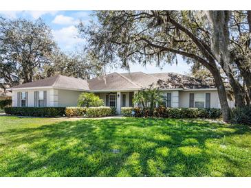 Charming single-story home with well-manicured lawn and mature landscaping at 1845 Farrington Dr, Lakeland, FL 33809