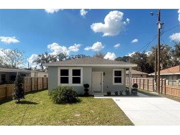 Charming single-story home with a well-manicured lawn, bright white trim, and a paved driveway at 388 Chinaberry Ave, Oviedo, FL 32765