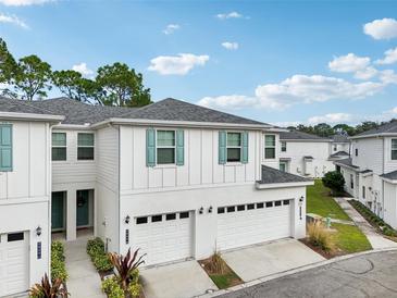 Two-story home with white exterior, two-car garage, and landscaping at 2920 Oak Park Way # Apt A, Orlando, FL 32822