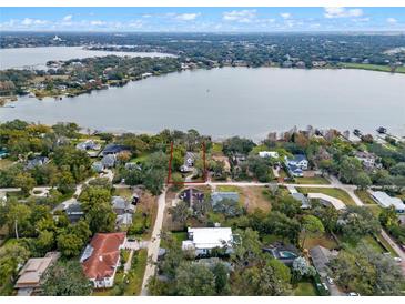 Stunning aerial view of lakefront home highlighting property lines and the beautiful surrounding landscape at 1003 Oakdale St, Windermere, FL 34786