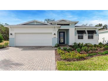 Charming single-story home with a two-car garage and a beautifully landscaped front yard at 1209 Cresswind Blvd, Deland, FL 32724