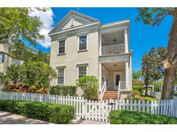 Charming two-story home featuring a white picket fence, front porch, and manicured landscaping at 4685 Anson Ln, Orlando, FL 32814