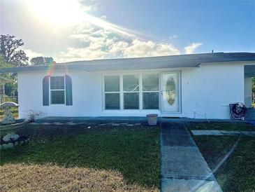 Newly renovated home with a fresh coat of paint and landscaped yard at 1625 Hastings Dr, Deltona, FL 32725