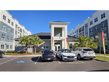 Modern apartment building with ample parking and landscaped grounds at 1210 Southstation Pl # 303, Orlando, FL 32809