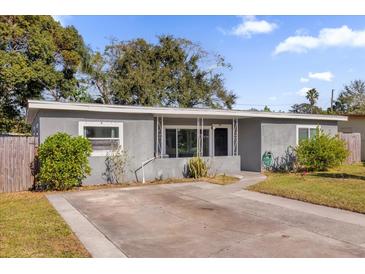 Charming single story home featuring a spacious front yard with tidy landscaping and a concrete driveway at 4535 Arch St, Orlando, FL 32808