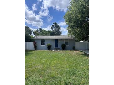 Charming single-story home featuring a well-maintained lawn, cute shrubs, and white privacy fence at 110 Oleander Ave, Auburndale, FL 33823