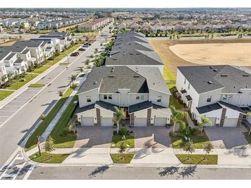 Excellent aerial view of new construction townhomes in a well-planned community in Florida at 953 Splash Shot Pl # 953, Davenport, FL 33896