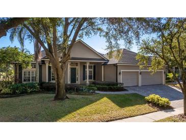 Well-maintained home with an attached three-car garage, and a lush front yard at 1913 Westover Reserve Blvd, Windermere, FL 34786