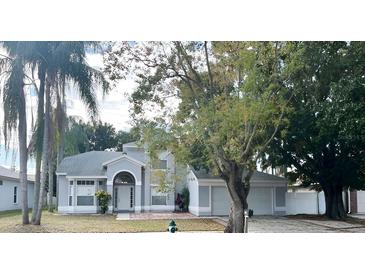 Charming two-story home with well-maintained landscaping and mature trees, creating an inviting curb appeal at 2708 Smithfield Dr, Orlando, FL 32837