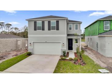 Beautiful two-story home featuring a two-car garage and well-maintained landscaping at 528 Carya Way, Auburndale, FL 33823
