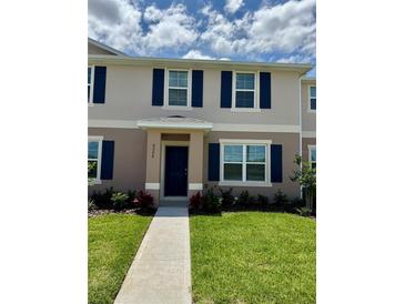 Charming two-story home with blue shutters and a well-manicured lawn at 6098 Galloping Dr, Apopka, FL 32712