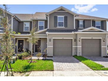 Charming townhome featuring a one-car garage and a beautifully landscaped front yard at 375 Sequoia Dr, Lake Wales, FL 33859