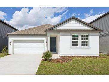 Charming one-story home featuring a two-car garage and manicured front lawn at 5715 Cattle Ranch Dr, St Cloud, FL 34771