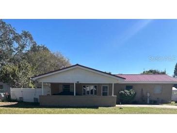 Charming single-story home featuring a covered front porch and a well-maintained lawn at 2521 Avenue A Sw, Winter Haven, FL 33880