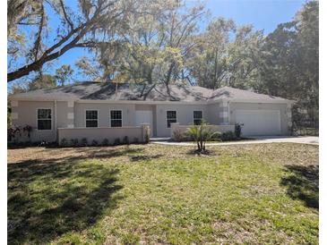 Charming single-story home featuring a well-manicured lawn and an attached two-car garage at 632 Oakhurst St, Altamonte Springs, FL 32701