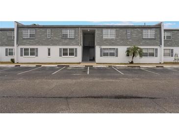 Two-story building exterior with gray siding and ample parking at 1000 S Semoran Blvd # 814, Winter Park, FL 32792